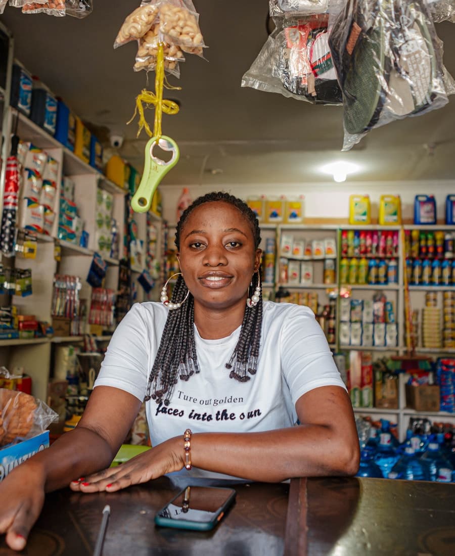 A shop owner behind her counter taking a digital payment